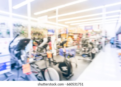 Blur Variety Of Fitness Equipment On Display At Sporting Goods Store In Houston, Texas, US. Defocused Pile Of Dumbbells, Weight, Strength Training, Stepper, Cardio Machine, Gym Room. Customer Shopping