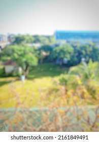 Blur View Of Beautiful Garden With Green Trees