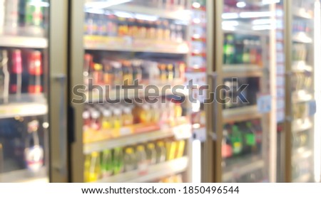 blur view of beverage displayed in refridgerators in convenience store. image of beverage cooler in market.
