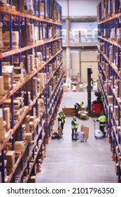 Blur warehouse background. Warehouse worker taking package in the shelf in a large warehouse in a large warehouse