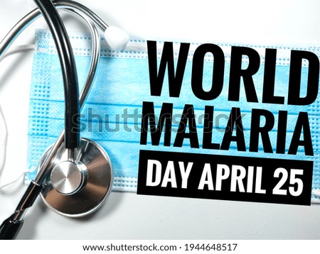 Blur word WORLD MALARIA DAY APRIL 25 on white background with blur face mask and blur stethoscope.