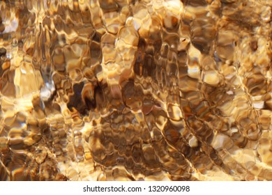 Blured abstract shot of golden sparkling sand on the shore of the Skiathos island, Greece as a natural background.