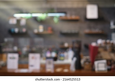 Blured Background Front View Of Coffee Shop Or Cafe Bar Restaurant Nobody Indoor. Empty Coffee Shop Interior Daytime With Wooden Design Counter Cement Wall In Background.