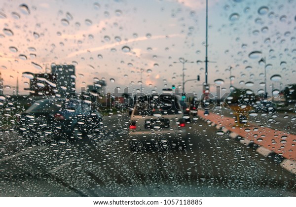 Blured
background with rains drop on glass and cars on the road, Road view
through car window blurry with heavy rain, Driving in rain, rainy
weather. Water drop rain on road blur background.
