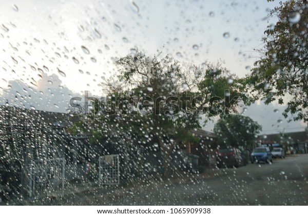 Blured
background with rains drop on glass and cars on the road, Road view
through car window blurry with heavy rain, Driving in rain, rainy
weather. Water drop rain on road blur background.
