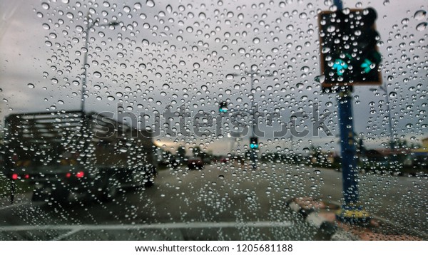 Blured background with rains drop on glass and
cars on the road, Road view through car window blurry with heavy
rain, Driving in rain, rainy
weather.