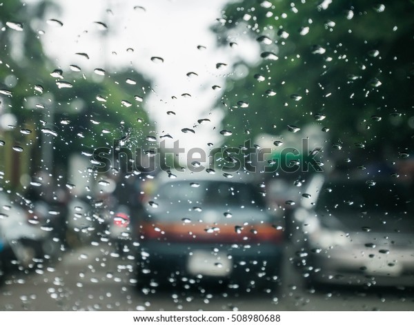 Blured background with rains drop on glass and
cars on the road, Road view through car window blurry with heavy
rain, Driving in rain, rainy
weather