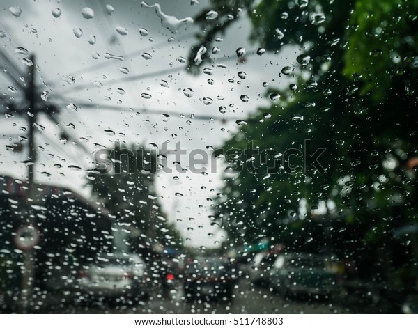 Blured background with rains drop on glass and
cars on the road, Road view through car window blurry with heavy
rain, Driving in rain, rainy
weather