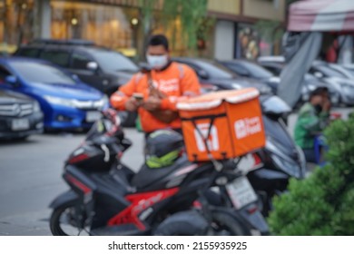 Blured ,food Delivery  Driver   At   Bangkok Thailand
