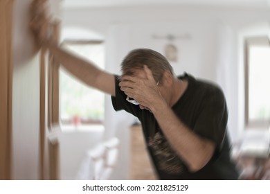 Blured photo of a man suffering from vertigo or dizziness or other health problem of brain or inner ear. - Shutterstock ID 2021825129