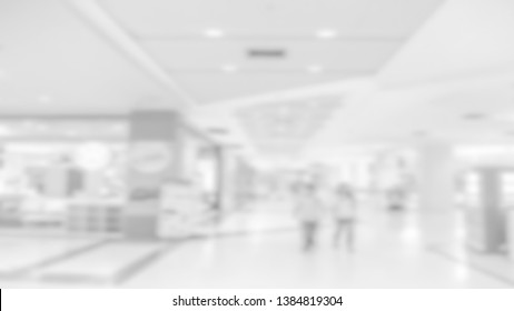 Blured soft white background look alike shopping center corridor with many shop along the way can be use for background for any shopping contents or for bussiness contents.