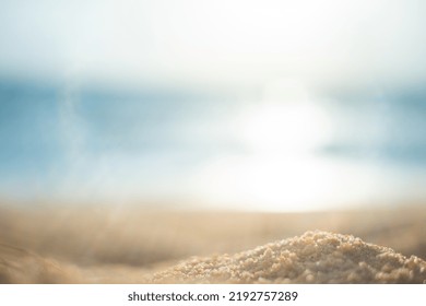 Blurr Sand Texture On Beach Blue Water Background With Sun Flare