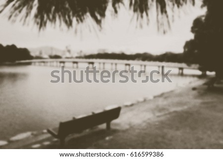 Blurred abstract background of blurred of bench at a lakeside Feeling lonely