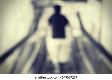 Blurred abstract background and can be illustration to article of people on escalator