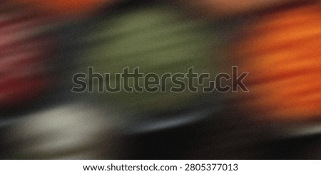 Blurred abstract background with diagonal streaks of red, orange, green, and gray. Textured, energetic, dynamic, vibrant color blend.