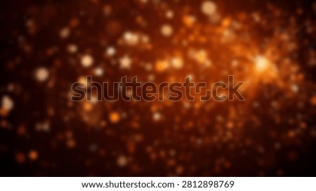 A blurred abstract background featuring a bokeh effect with warm orange and gold glowing lights, creating a festive and magical atmosphere.