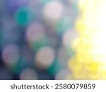 a blurred, abstract background featuring soft circular bokeh lights in shades of blue, green, yellow, and white.