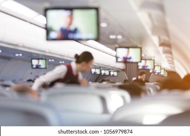 Blurred abstract background of Flight attendant serving passengers on the plane. - Shutterstock ID 1056979874