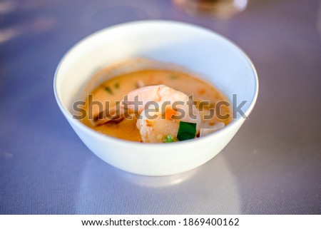 Blurred abstract background of hands eating on a table like seafood (Baked shrimp vermicelli, deep fried sea bass with fish sauce, yum squid) eaten alongside soft drinks, while on vacation with family