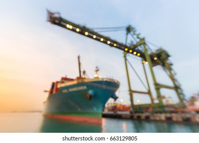 Blurred Abstract Background Of Industrial Port With Container Ship At Dusk