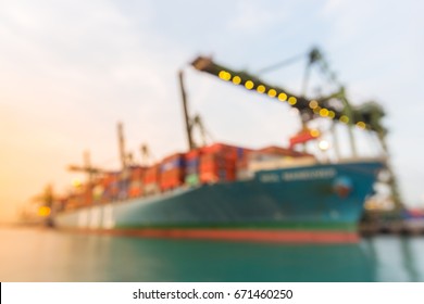 Blurred Abstract Background Of Industrial Port With Container Ship At Dusk