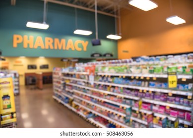 Blurred abstract background inside pharmacy store with arranged variation of pharmaceutical and medical supplies product in label on shelves display. Indoor space of drug store with blurred medicines.