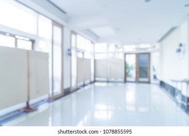 Blurred abstract background interior view looking out toward to empty office lobby and entrance doors and glass curtain wall with frame - blue white balance processing style - Shutterstock ID 1078855595