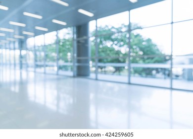 Blurred Abstract Background Interior View Looking Out Toward To Empty Office Lobby And Entrance Doors And Glass Curtain Wall With Frame - Blue White Balance Processing Style