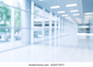 Blurred Abstract Background Interior View Looking Out Toward To Empty Office Lobby And Entrance Doors And Glass Curtain Wall With Frame - Blue White Balance Processing Style