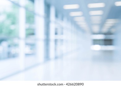 Blurred Abstract Background Interior View Looking Out Toward To Empty Office Lobby And Entrance Doors And Glass Curtain Wall With Frame - Blue White Balance Processing Style