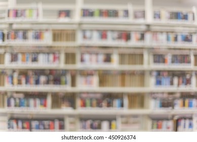 Blurred Abstract Background Of Media Box Shelf In A Modern Public American Library Interior With Rows Of DVD, CD, Blu-ray Discs. Self-study, Educational, Leisure Concept Background.