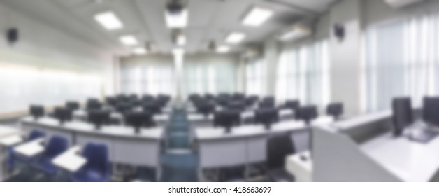 Blurred Abstract Background Of Monitors In Computer Class In University With Nobody. Blurry Image Of Empty Room With Row Of PC In Engineering Lab In Campus.School Internet Safety Week