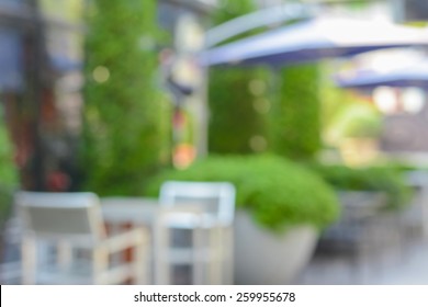 Blurred Abstract Background Of Outdoor Cafe In The Garden