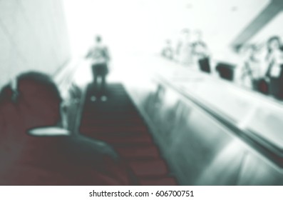 Blurred abstract background of People using escalator