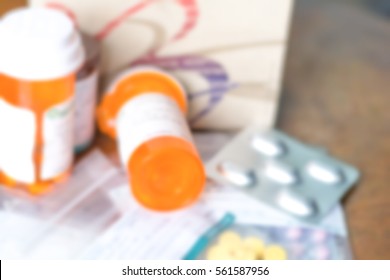 Blurred Abstract Background Pile Of Various Expired Doctor Prescription Medicines In Bottle And Plastic Bags. Blurry View Drugs, Antibiotic,paracetamol, Vitamins From Hospital On Wood Background.