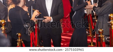 Blurred abstract background with red carpet and celebrities