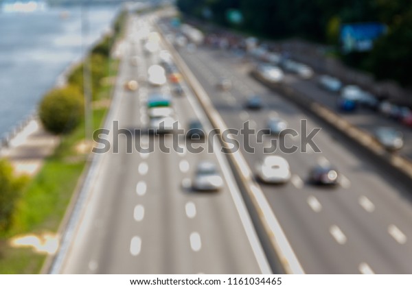Blurred abstract background of traffic\
cars on the multi lane highway during rush\
hour