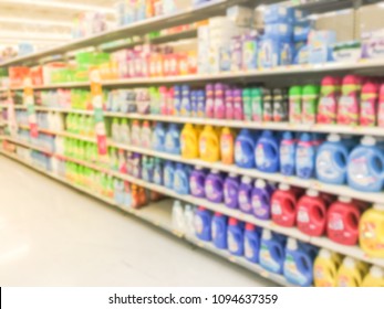 Blurred Abstract Bleach, Fabric Softener, Laundry Detergent, All Purpose Cleaners Shelves In Modern Grocery Retail Store. Defocused Variety Of Cleaning, Grocery, Household Aisle From Floor To Ceiling