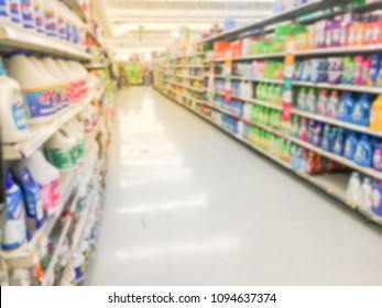 Blurred Abstract Bleach, Fabric Softener, Laundry Detergent, All Purpose Cleaners Shelves In Modern Grocery Retail Store. Defocused Variety Of Cleaning, Grocery, Household Aisle From Floor To Ceiling