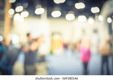 Blurred Abstract Of Cameraman Operator And Assistant Recording/videotaping An Interview With A Fit And Lifestyle Female Athlete Runner At The Conventional Hall Of Marathon Event Expo. Vintage Tone.