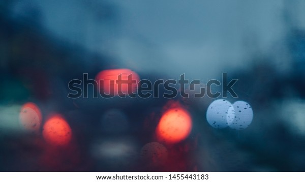 blurred abstract of cars on street in city through\
front car window