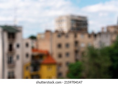 Blurred Abstract City Background, Blue Sky Buildings Green Trees.