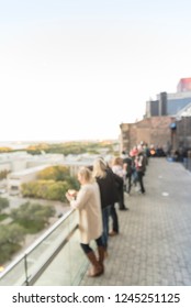 Blurred Abstract Diverse Group Of People In Formal Dress Hanging Out At Rooftop Bar In Downtown Chicago, USA. Business Happy Hour Concept, Autumn Season