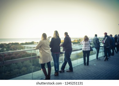 Blurred Abstract Diverse Group Of People In Formal Dress Hanging Out At Rooftop Bar In Downtown Chicago, USA. Business Happy Hour Concept, Autumn Season