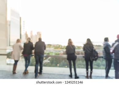 Blurred Abstract Diverse Group Of People In Formal Dress Hanging Out At Rooftop Bar In Downtown Chicago, USA. Business Happy Hour Concept, Autumn Season