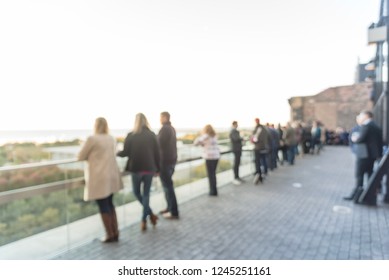 Blurred Abstract Diverse Group Of People In Formal Dress Hanging Out At Rooftop Bar In Downtown Chicago, USA. Business Happy Hour Concept, Autumn Season