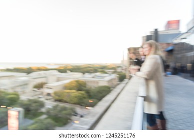 Blurred Abstract Diverse Group Of People In Formal Dress Hanging Out At Rooftop Bar In Downtown Chicago, USA. Business Happy Hour Concept, Autumn Season