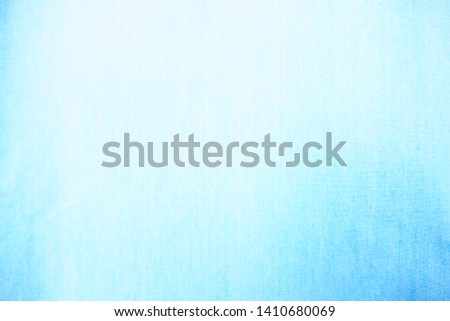 Blurred and abstract focus of beautiful quality cotton mixed with polyester fabric in bright pastel blue tone for textile texture, seamless pattern, and cool banner background