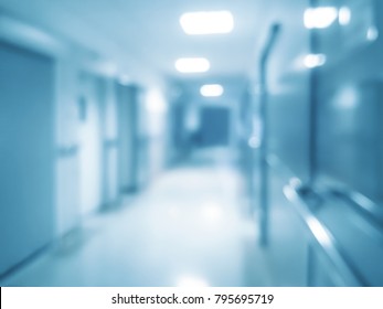Blurred abstract hospital background - corridor with rooms for patients and bokeh lights (blue filter effect).
