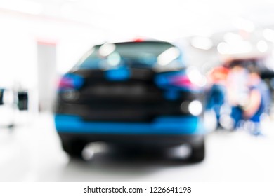 Blurred Abstract Image Of Man Worker With Car In Body Shop. Blur Car Auto Service. Car Bokeh. Blurred Background With Car In Garage. Vehicle Maintenance In Auto Repair Service. Blurry Service Station